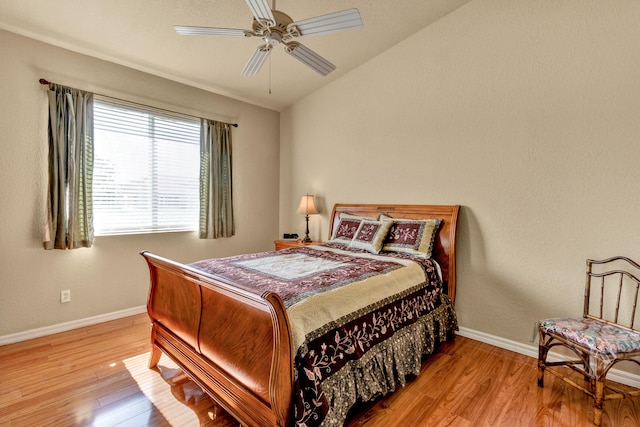 bedroom featuring wood-type flooring, vaulted ceiling, and ceiling fan