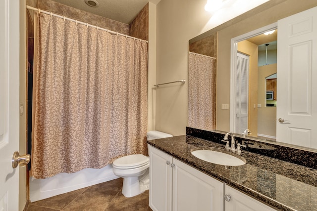 bathroom featuring tile patterned flooring, vanity, and toilet