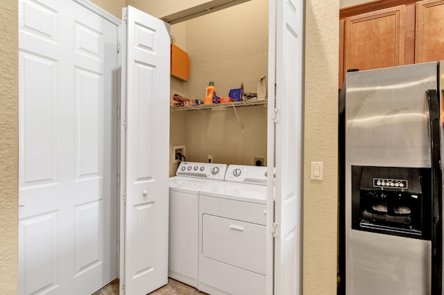 washroom featuring a textured ceiling and washing machine and clothes dryer