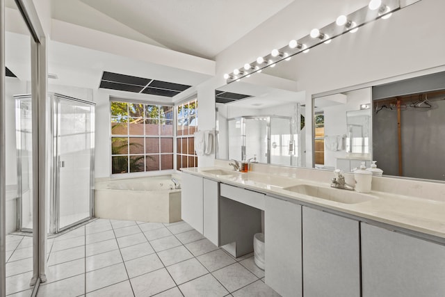 bathroom with vanity, vaulted ceiling, tile patterned floors, and separate shower and tub