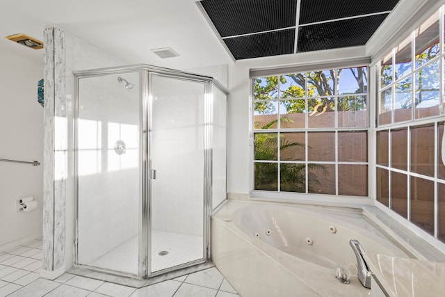 bathroom with tile patterned floors and shower with separate bathtub