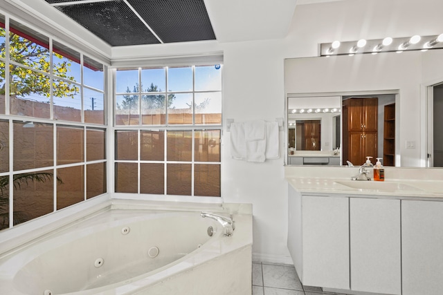 bathroom featuring a tub, tile patterned flooring, and vanity