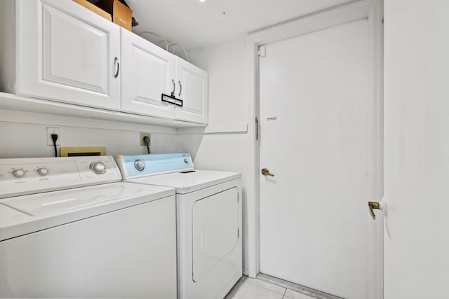 laundry area with washer and dryer and cabinets