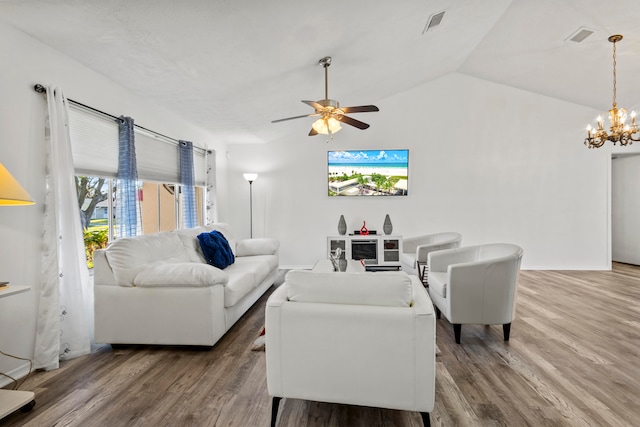 living room with hardwood / wood-style floors, ceiling fan with notable chandelier, and vaulted ceiling