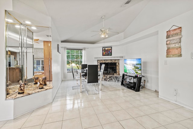 dining room featuring ceiling fan, lofted ceiling, and light tile patterned flooring