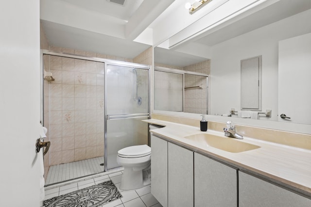 bathroom with tile patterned floors, vanity, toilet, and an enclosed shower