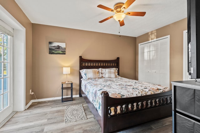 bedroom with ceiling fan, a closet, and hardwood / wood-style flooring