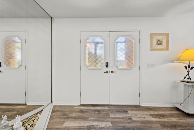 entrance foyer featuring french doors and hardwood / wood-style flooring