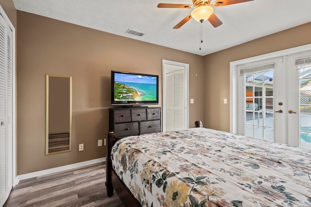 bedroom with french doors, a textured ceiling, hardwood / wood-style flooring, and ceiling fan