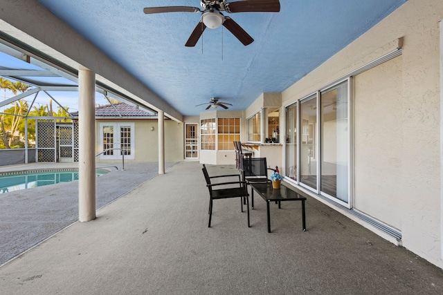 view of patio / terrace with a lanai, ceiling fan, and french doors