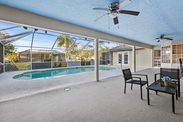 view of pool featuring french doors, a patio, ceiling fan, and a lanai