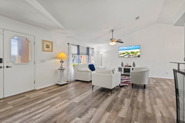 living room featuring hardwood / wood-style flooring, ceiling fan, and lofted ceiling