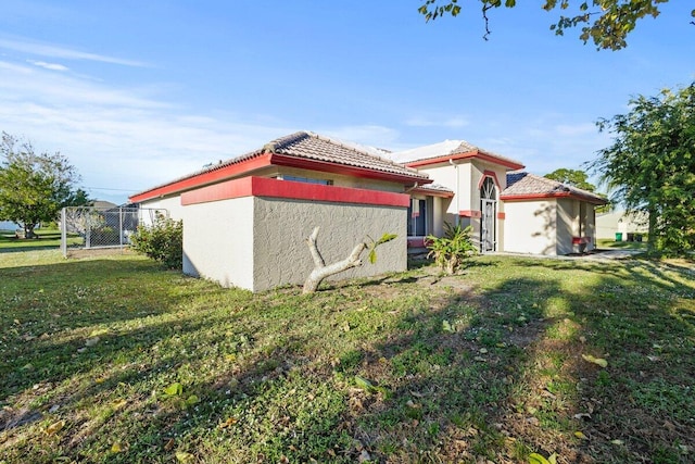 view of side of home featuring a yard