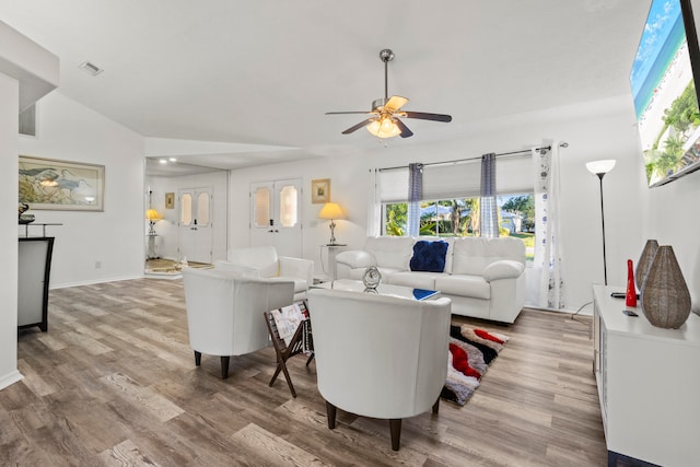 living room featuring wood-type flooring, ceiling fan, and lofted ceiling