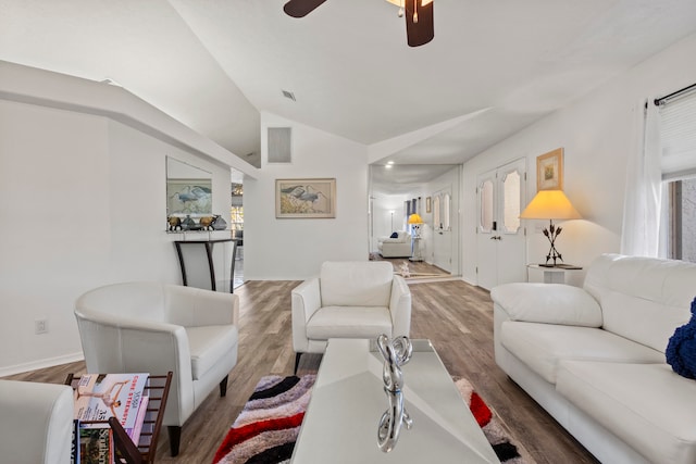 living room featuring ceiling fan, vaulted ceiling, and hardwood / wood-style flooring