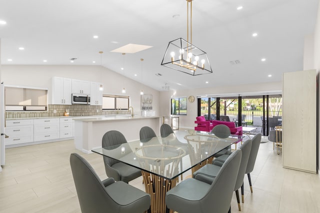 dining room with lofted ceiling with skylight and sink