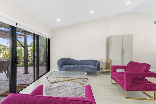 tiled living room featuring vaulted ceiling