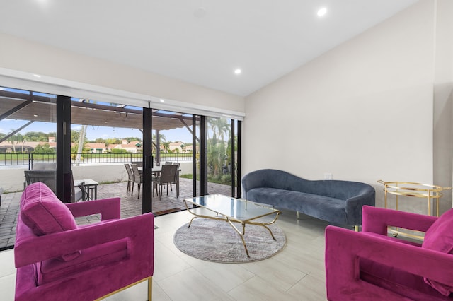 living room featuring light tile patterned floors, plenty of natural light, and lofted ceiling