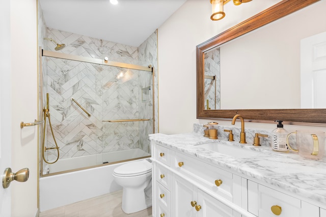 full bathroom with combined bath / shower with glass door, vanity, and toilet