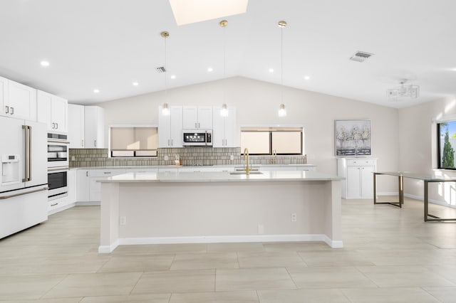 kitchen with pendant lighting, a center island, white cabinetry, and stainless steel appliances