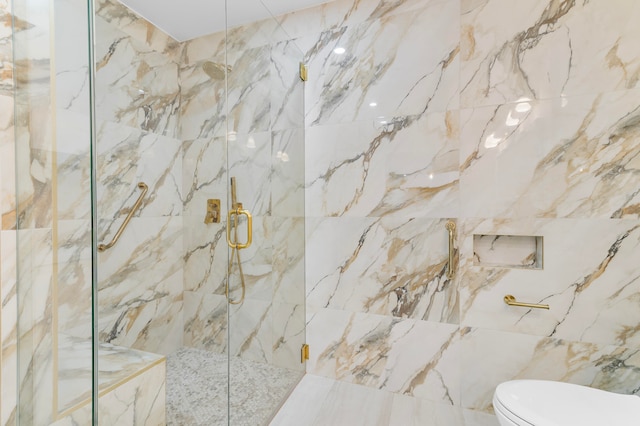 bathroom featuring toilet, an enclosed shower, and tile walls