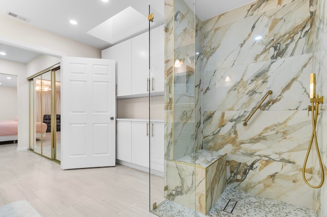 bathroom with a skylight and walk in shower