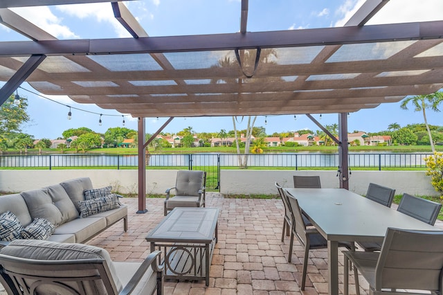 view of patio / terrace with a pergola, an outdoor living space, and a water view