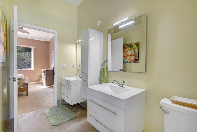 bathroom featuring toilet, vanity, tile patterned floors, and crown molding