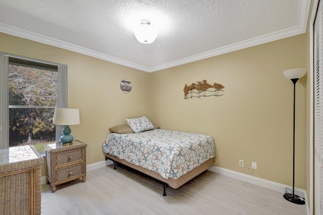 bedroom featuring crown molding, hardwood / wood-style floors, and a textured ceiling