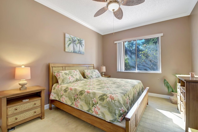 bedroom with a textured ceiling, ceiling fan, crown molding, and light carpet