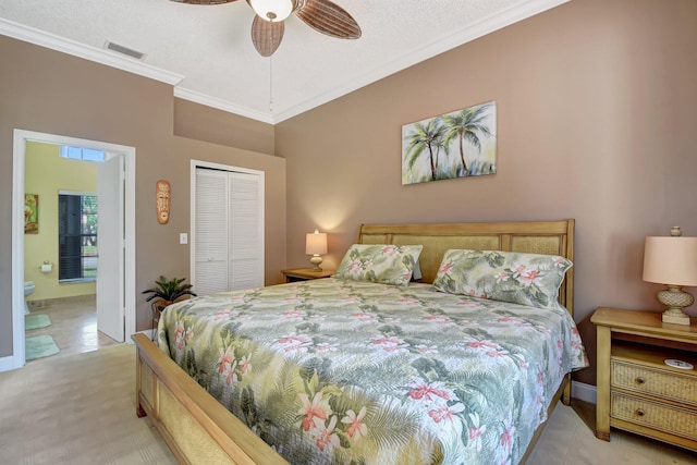 bedroom featuring ensuite bathroom, light colored carpet, ceiling fan, crown molding, and a closet