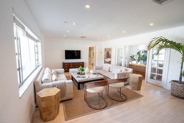 living area featuring recessed lighting, visible vents, and light wood-style flooring