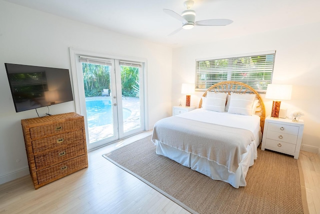 bedroom featuring ceiling fan, light wood-type flooring, access to outside, and french doors