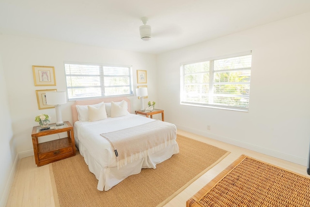 bedroom with ceiling fan and light hardwood / wood-style flooring