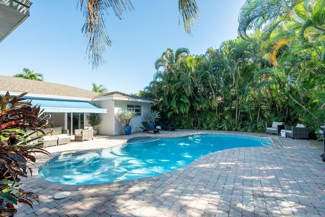 view of swimming pool with an outdoor living space and a patio