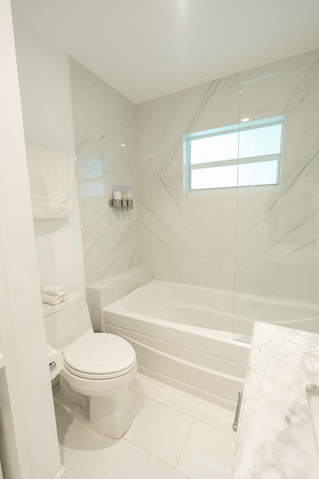 full bathroom featuring vanity, tile patterned floors, tiled shower / bath combo, and toilet