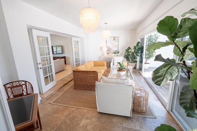 sitting room featuring french doors and an inviting chandelier