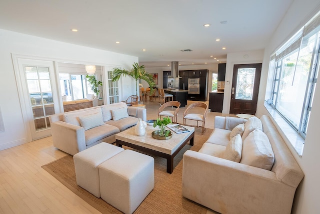 living room featuring recessed lighting and light wood-style flooring