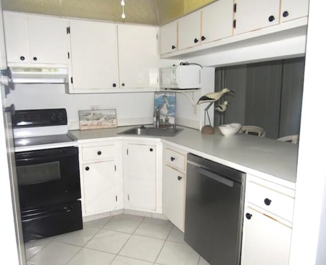 kitchen featuring black range with electric stovetop, dishwasher, light tile patterned floors, extractor fan, and white cabinets