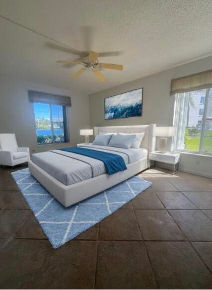 tiled bedroom with ceiling fan and a textured ceiling