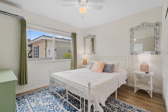 bedroom with a wall mounted AC and ceiling fan