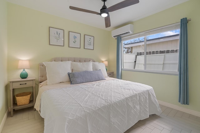 bedroom featuring ceiling fan, light parquet floors, and a wall mounted AC