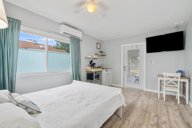 bedroom with a wall mounted AC, ceiling fan, and light hardwood / wood-style floors