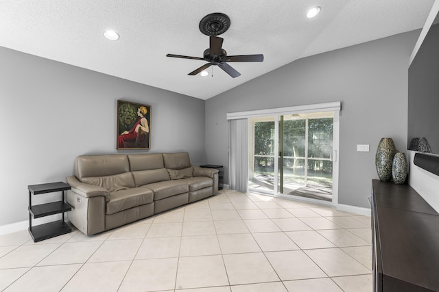 living room featuring lofted ceiling, a textured ceiling, ceiling fan, and light tile patterned floors