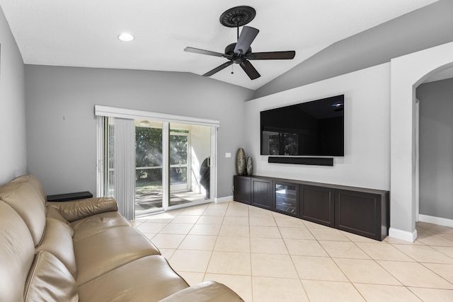 tiled living room featuring ceiling fan and vaulted ceiling