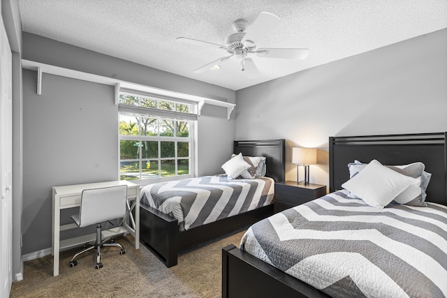 bedroom with ceiling fan, carpet, and a textured ceiling