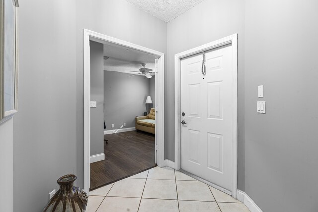 office area with a textured ceiling, dark wood-type flooring, and ceiling fan