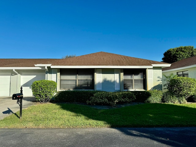 view of side of home featuring a garage and a lawn