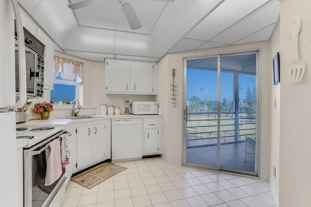 kitchen featuring white appliances, white cabinetry, ceiling fan, and sink