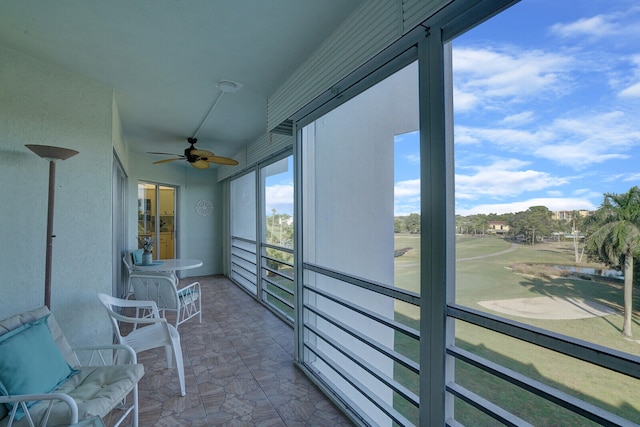 sunroom / solarium featuring ceiling fan